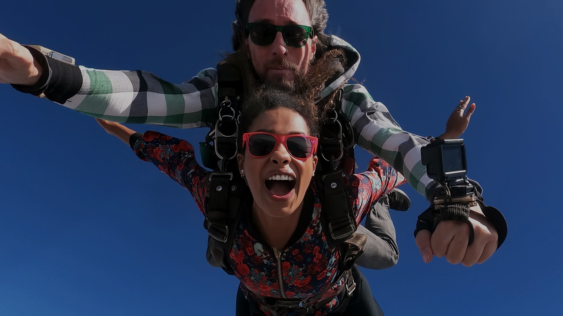 A man and a woman skydiving